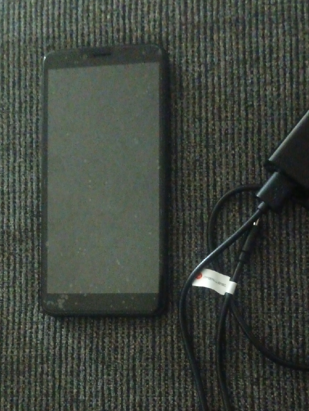 Black Smartphone with Charger - Reliable Mobile Device